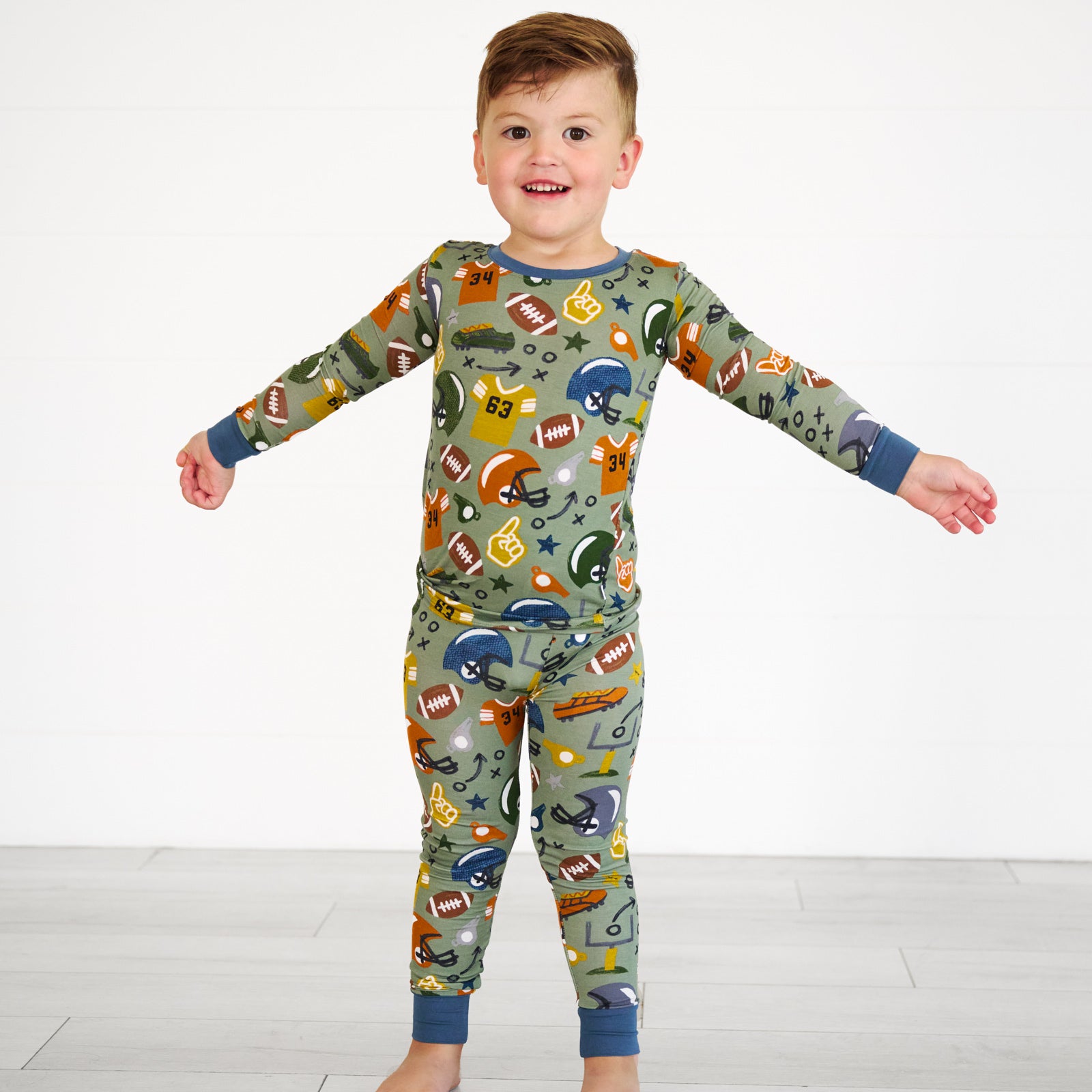 Boy wearing the touchdown-time-two-piece-pajama-set