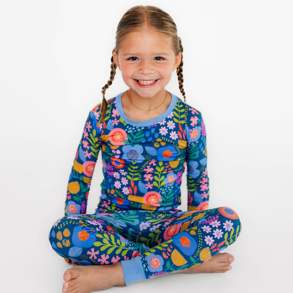 Girl sitting wearing the Folk Floral Two-Piece Pajama Set