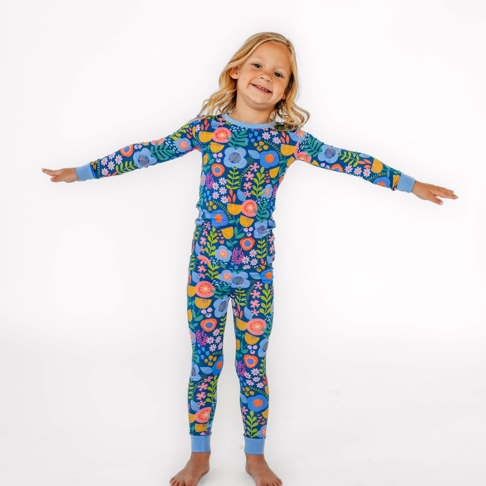 Child posing while wearing the Folk Floral Two-Piece Pajama Set