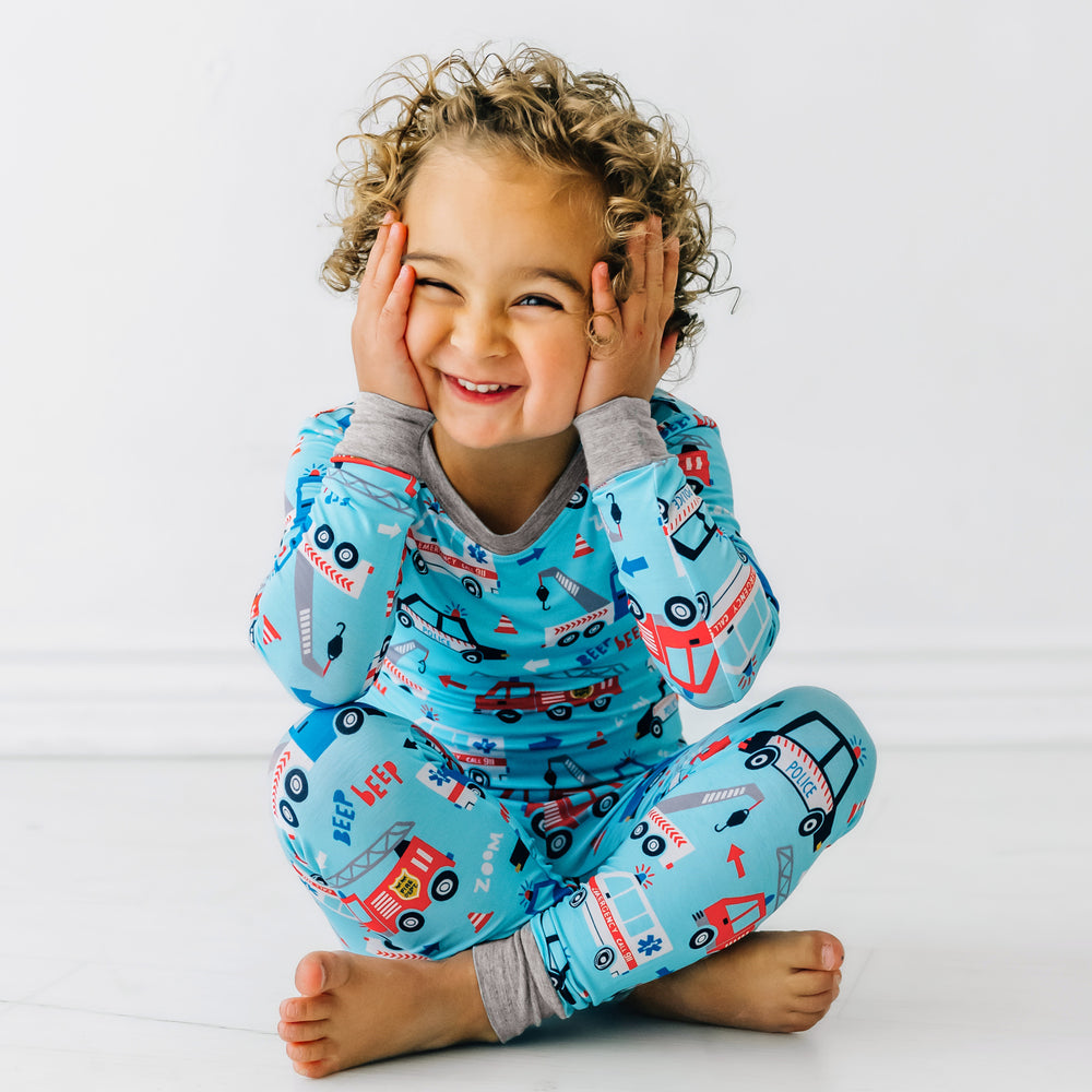 Alternate image of a child sitting wearing a To The Rescue two piece pajama set