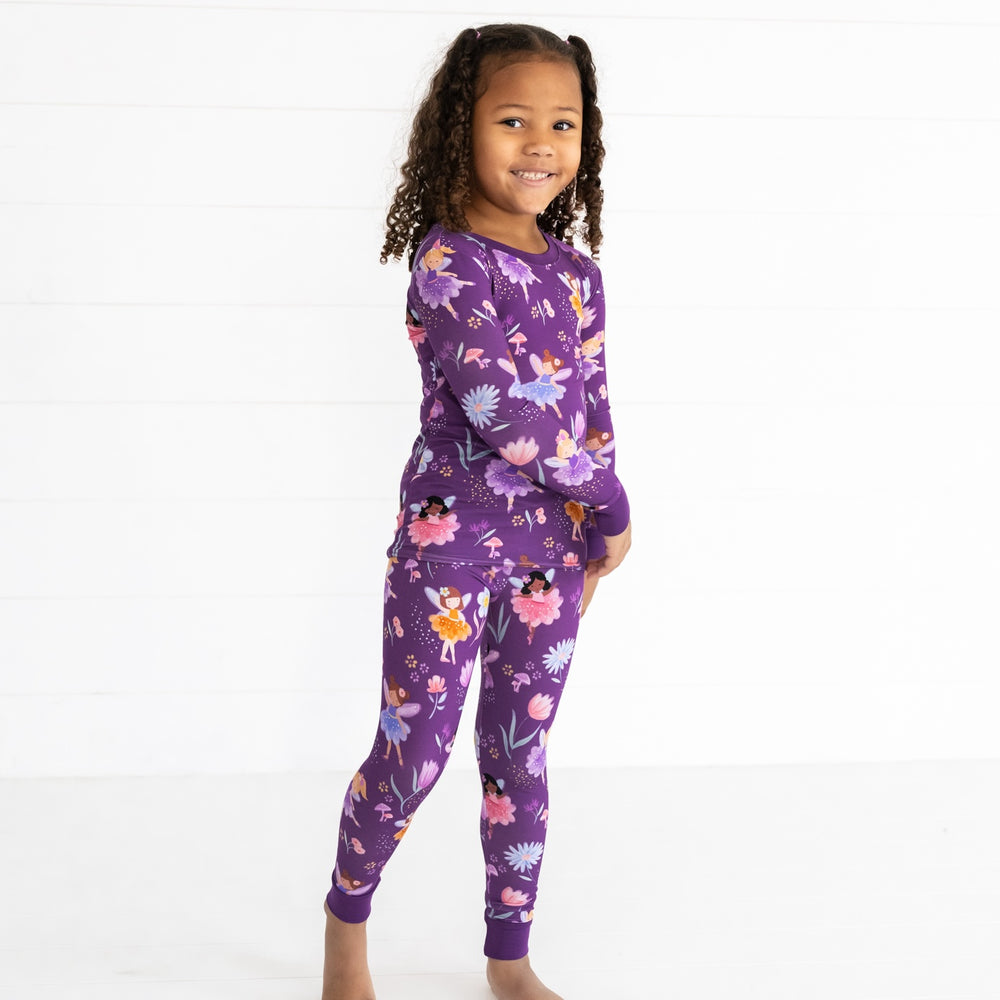 Smiling girl posing while wearing the Garden Fairies Two-Piece Pajama Set