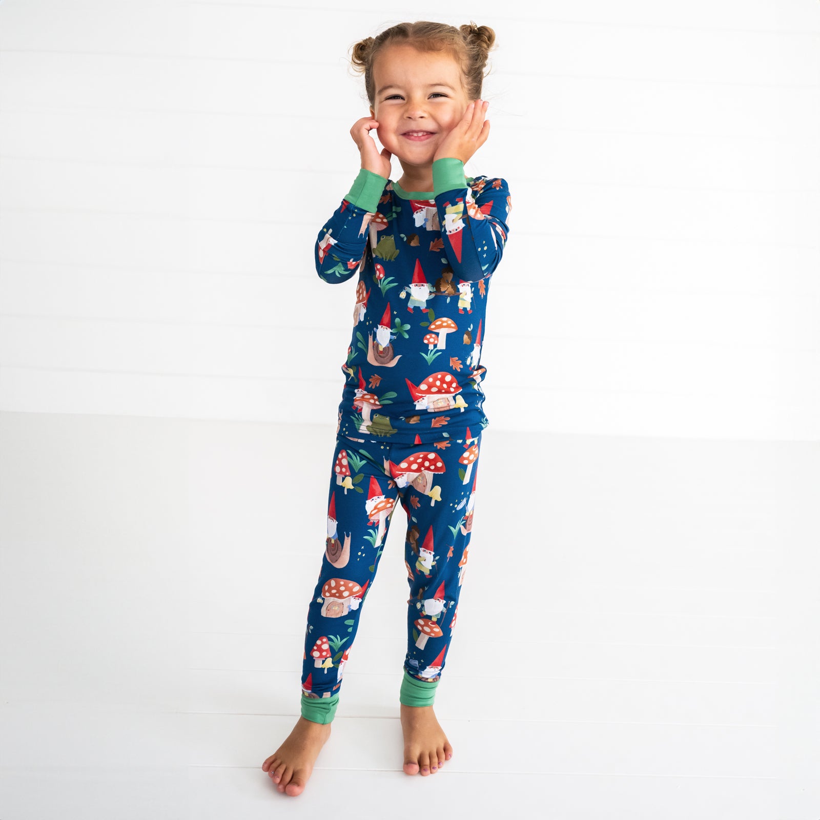 Smiling girl wearing the Forest Gnomes Two-Piece Pajama Set