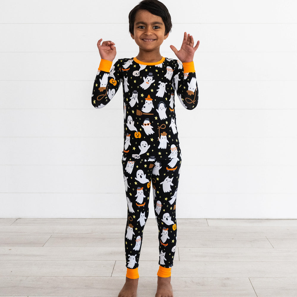 Boy posing while wearing the Friendly Ghosts Two-Piece Pajama Set