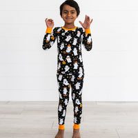 Boy posing while wearing the Friendly Ghosts Two-Piece Pajama Set