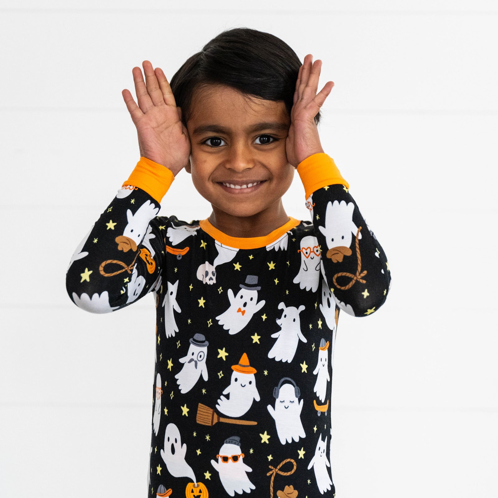 Close up image boy wearing the top in the Friendly Ghosts Two-Piece Pajama Set