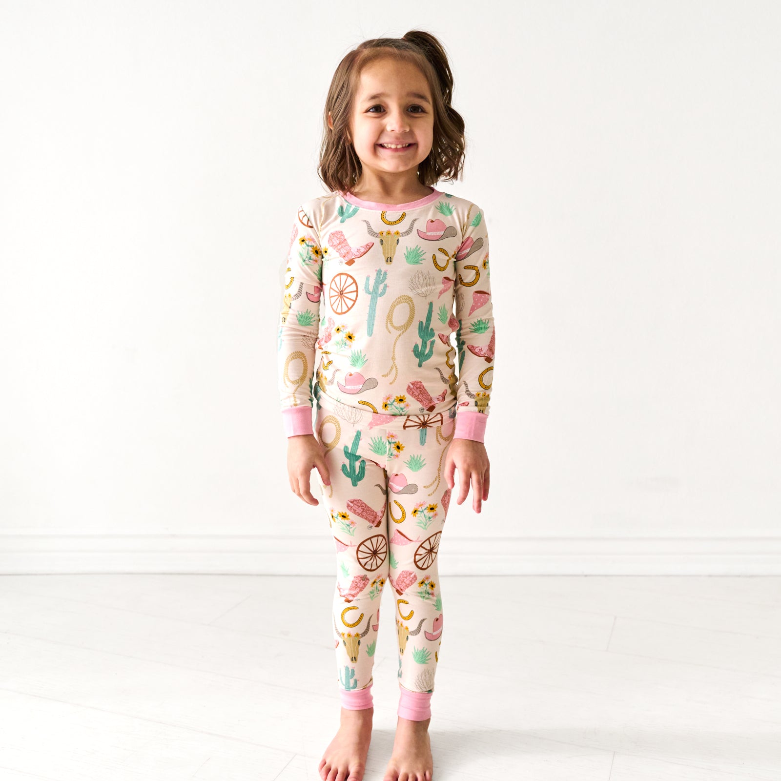 Child wearing a Pink Ready to Rodeo two piece pajama set