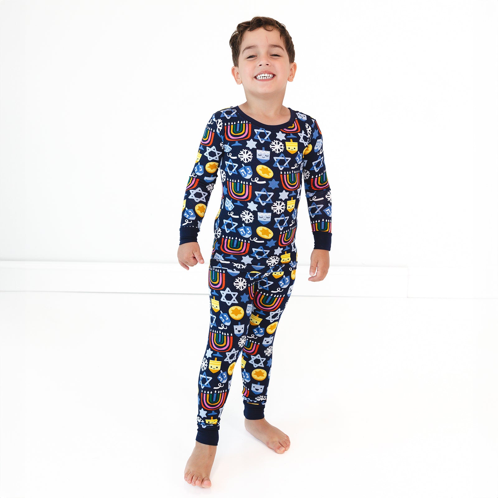 Child wearing a Playful Dreidels Two-Piece Pajama Set