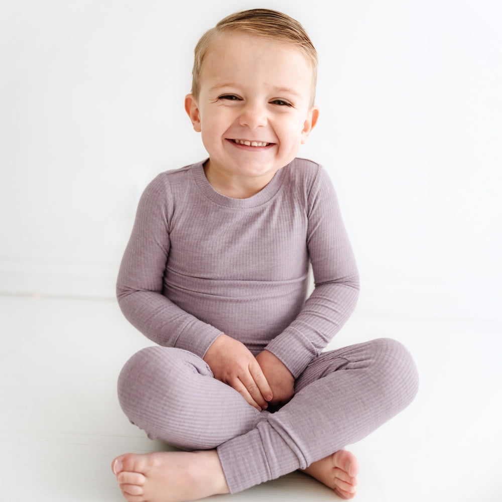 Click to see full screen - Child sitting wearing Heather Smokey Lavender Ribbed two piece pajama set