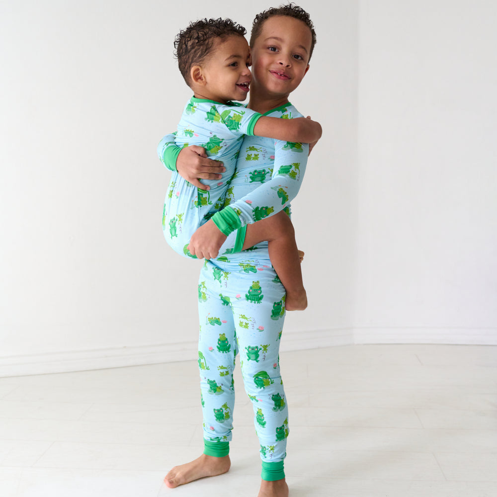 Two children wearing matching Leaping Love pajamas