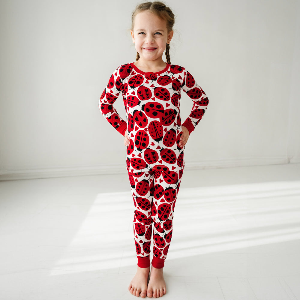 Click to see full screen - Child wearing a Love Bug printed two-piece pajama set