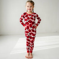 Child wearing a Love Bug printed two-piece pajama set