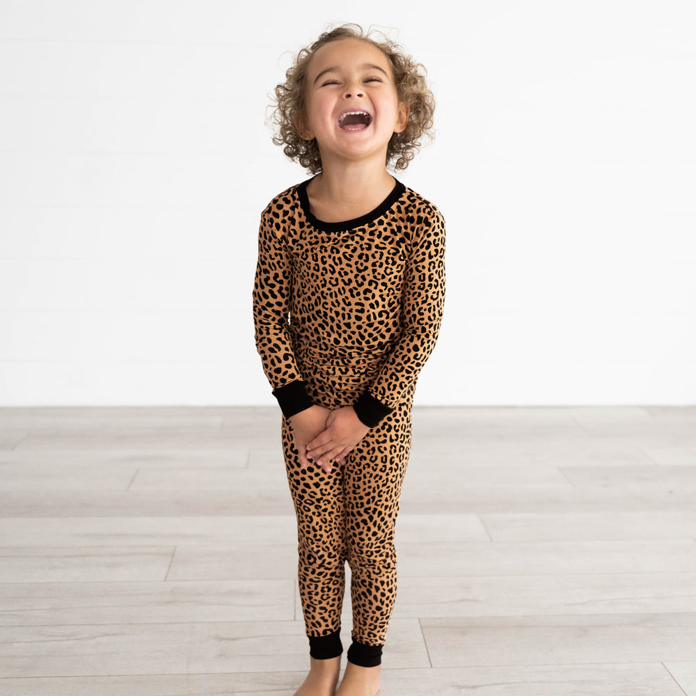 Girl smiling while wearing the Classic Leopard Two-Piece Pajama Set