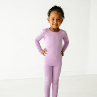 Child posing wearing a Light Orchid two piece pajama set