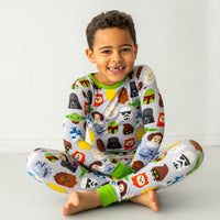 Child sitting on the ground wearing a Legends of the Galaxy two-piece pajama set