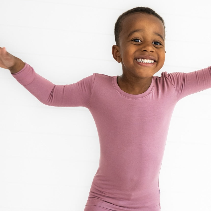 Close up image of a child wearing Cozy Dusty Plum two piece pj set