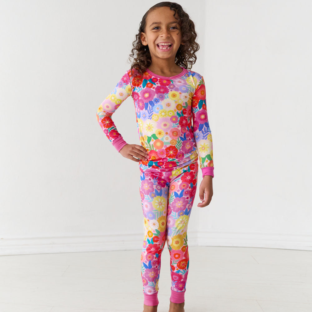 Child wearing a Rainbow Blooms two-piece pajama set