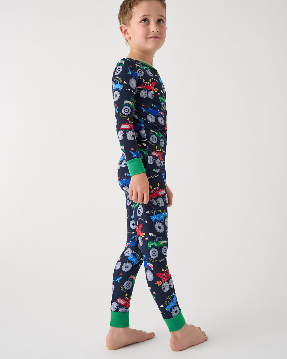 Standing boy wearing the Monster Truck Madness Two-Piece Pajama Set