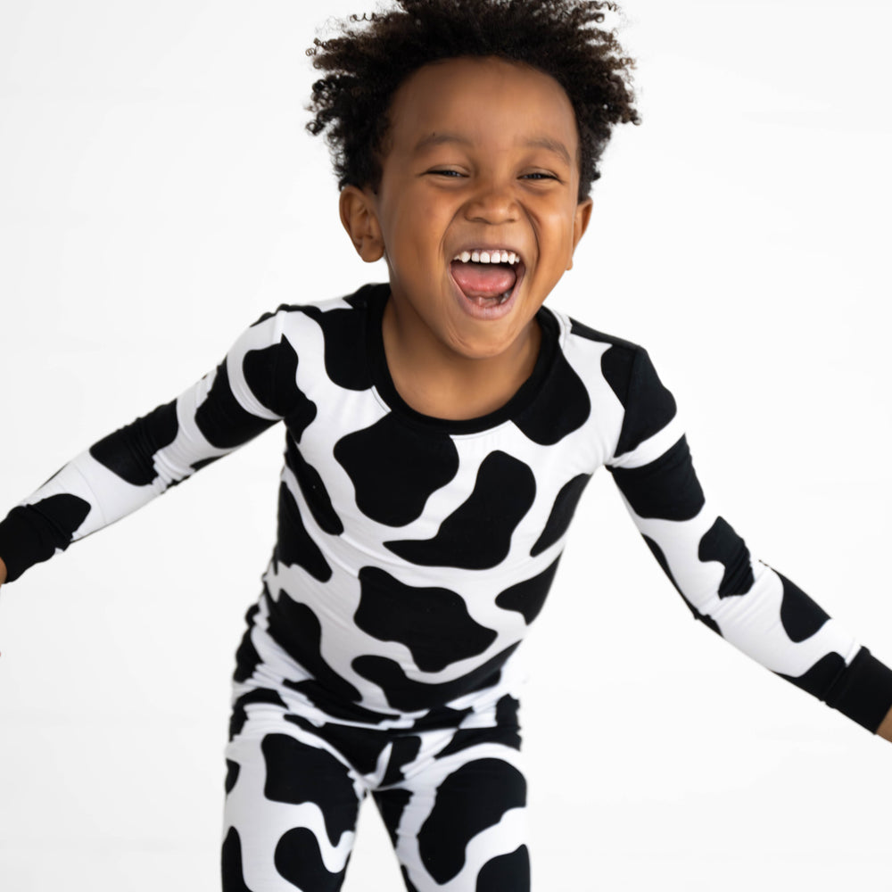 Boy posing while wearing the Moo Crew Two-Piece Pajama Set