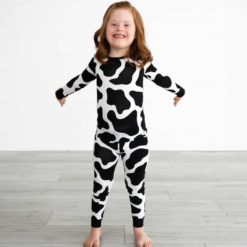 Girl posing while wearing the Moo Crew Two-Piece Pajama Set