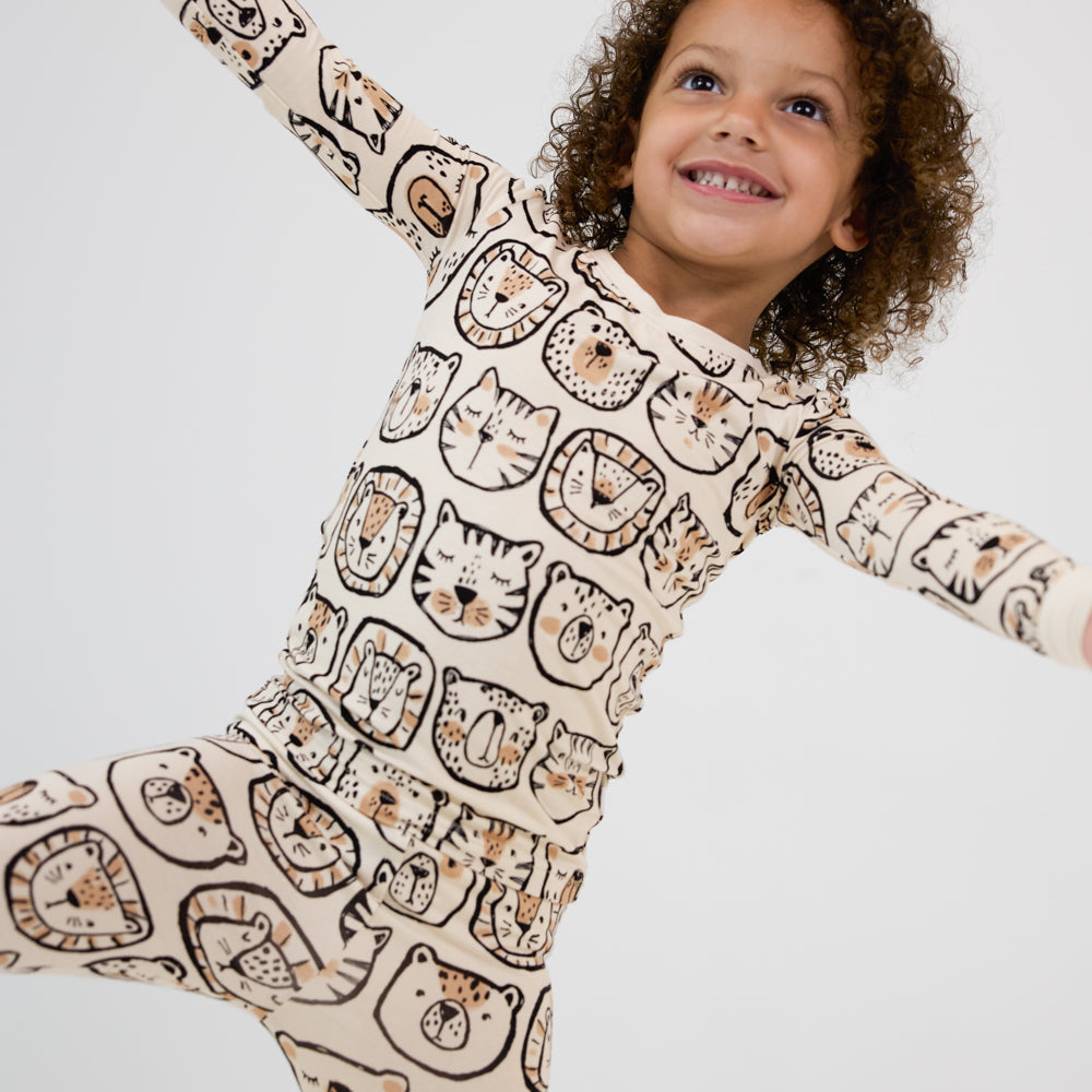 alternate image of a child posing wearing a Lions, Tigers, and Bears two piece pj set