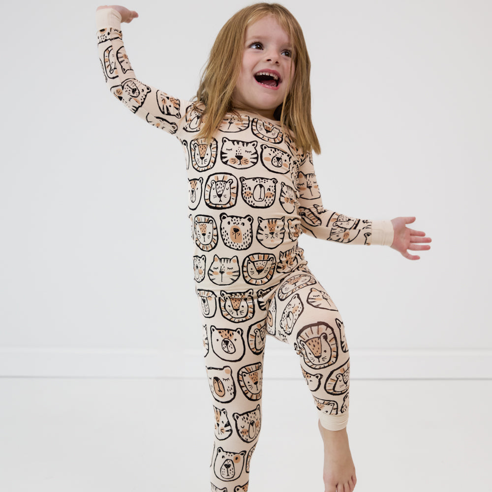 child dancing and wearing a Lions, Tigers, and Bears two piece pj set