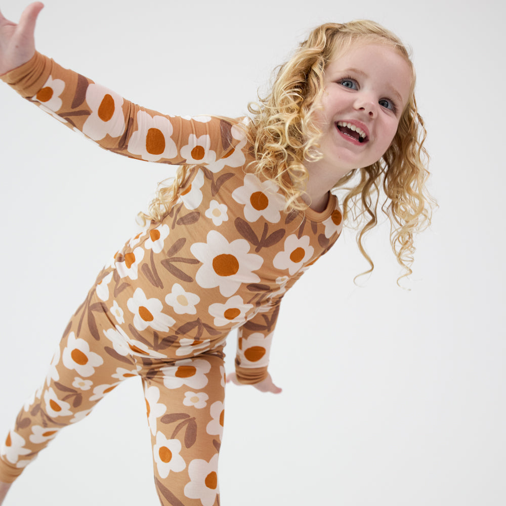 Child posing wearing a Daisy Daydream two piece pajama set