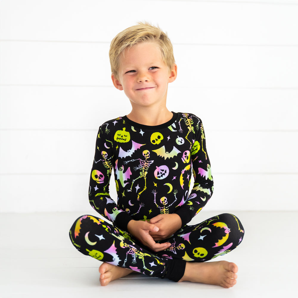 Child sitting wearing a Cool Ghouls two piece pj set