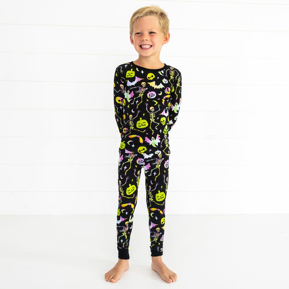 Child posing wearing a Cool Ghouls two piece pj set