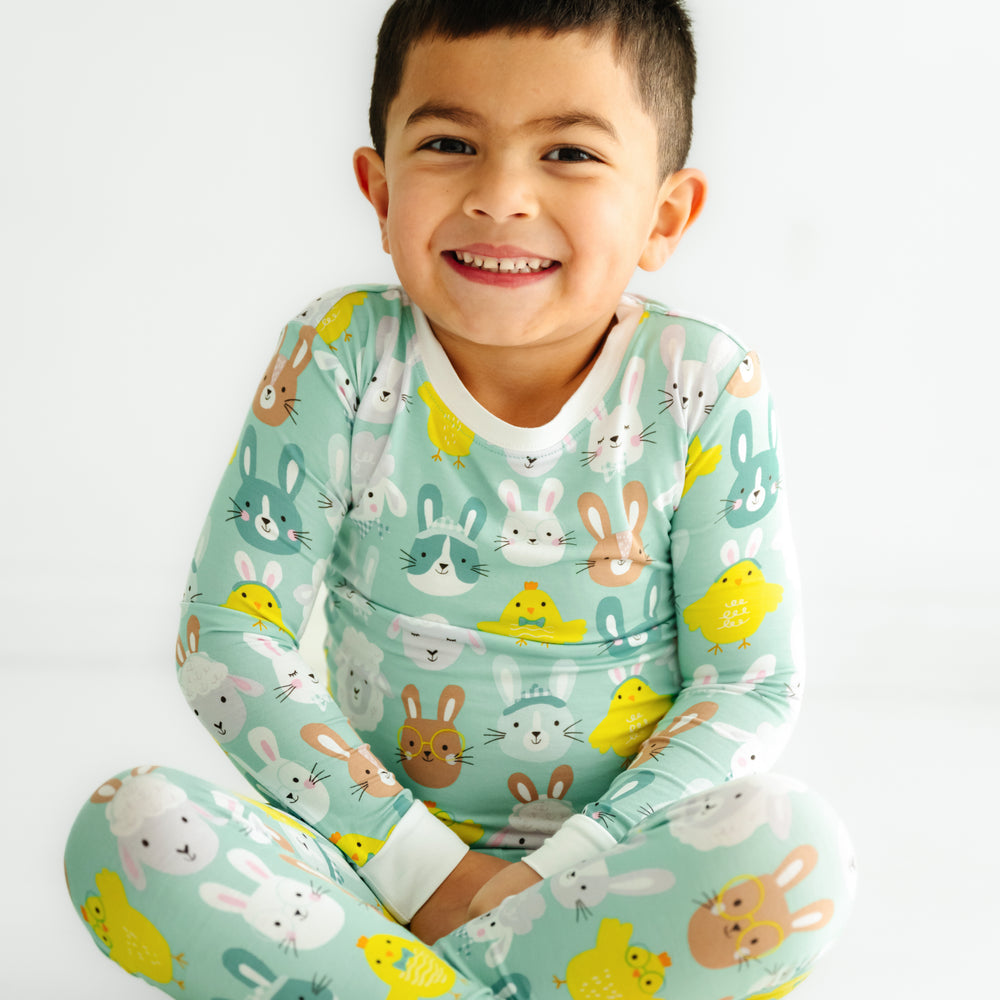 Click to see full screen - Close up image of a child sitting wearing a Aqua Pastel Parade two piece pajama set