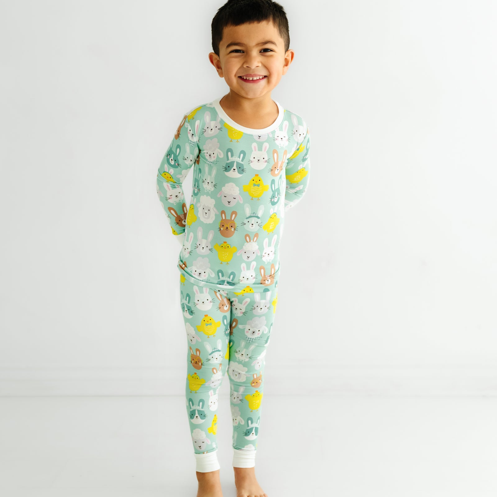 Child posing wearing a Aqua Pastel Parade two piece pajama set