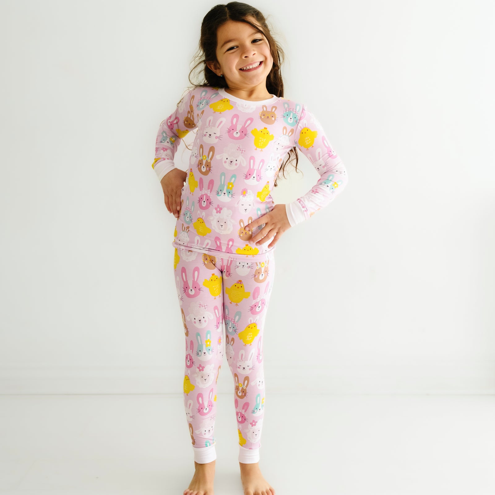 Child posing wearing Pink Pastel Parade two piece pajama set