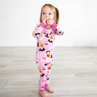 Girl wearing the Pink Glowing Ghouls Two-Piece Pajama Set