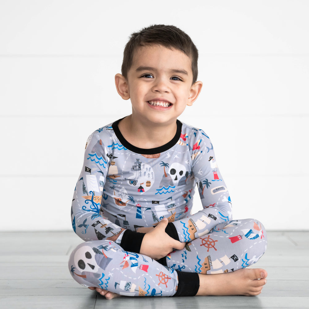Alternative image of child sitting while in the Pirate's Map Two-Piece Pajama Set