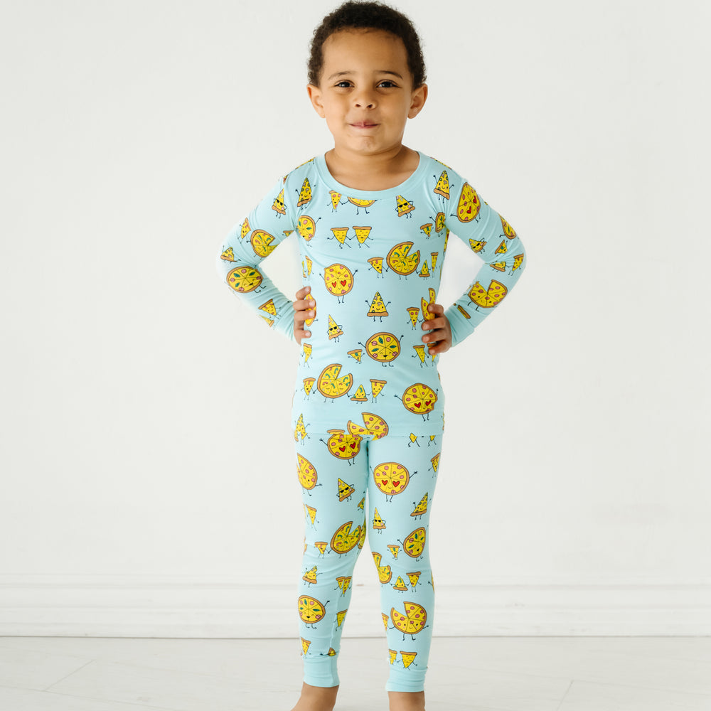 Child posing wearing a Pizza Pals two piece pajama set