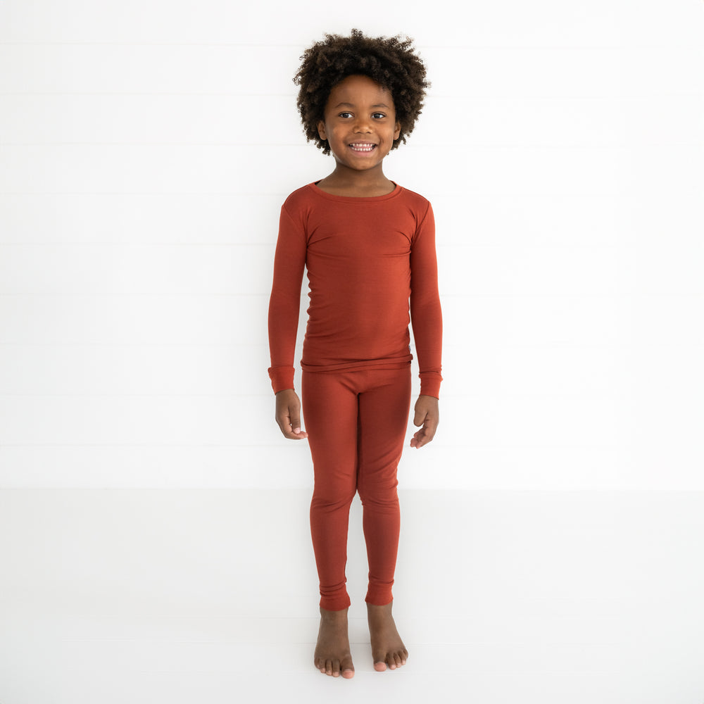 Child wearing a Cozy Rust two piece pj set