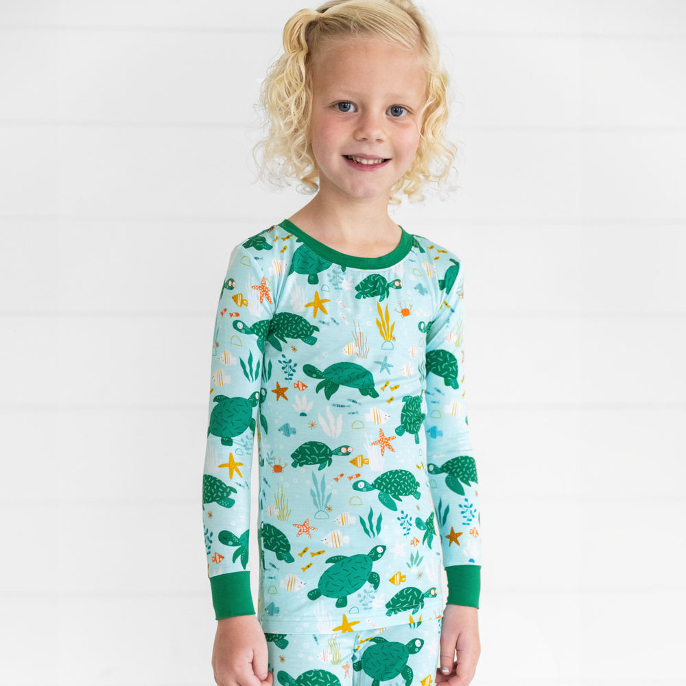 Close up image of a child wearing Sea Turtle Friends two piece pj set