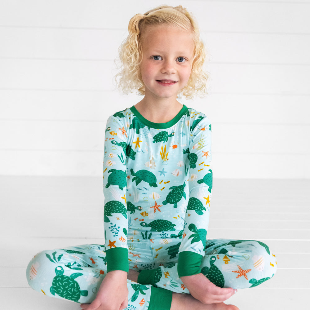 Child sitting wearing Sea Turtle Friends two piece pj set