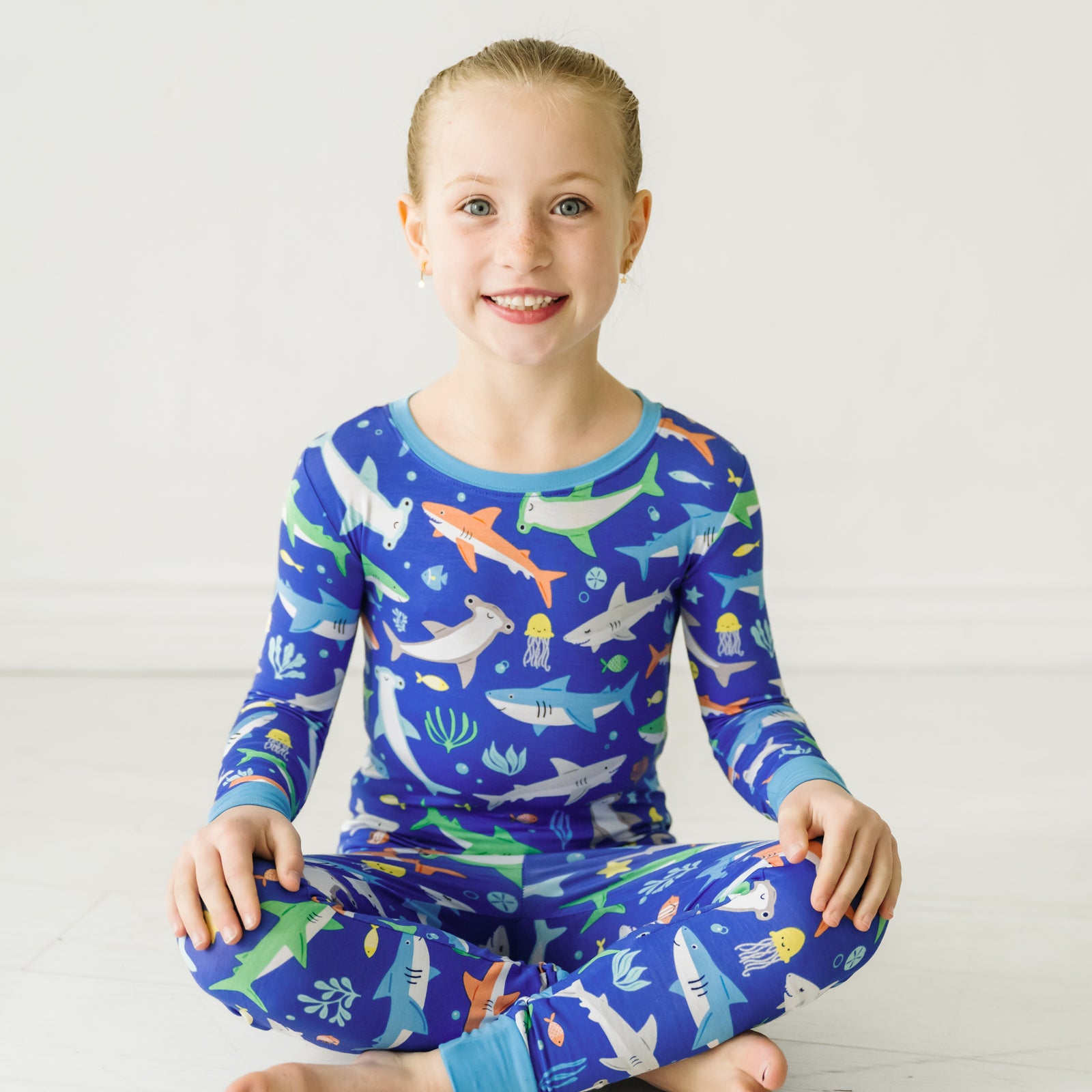 Alternate image of a child sitting on the ground wearing a Rad Reef two-piece pajama set