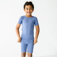Child posing wearing Slate Blue two piece short sleeve and shorts pajama set