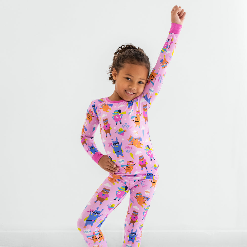 Child posing in the Pink Sleepy Heroes Two-Piece Long Sleeve & Pants Pajama Set