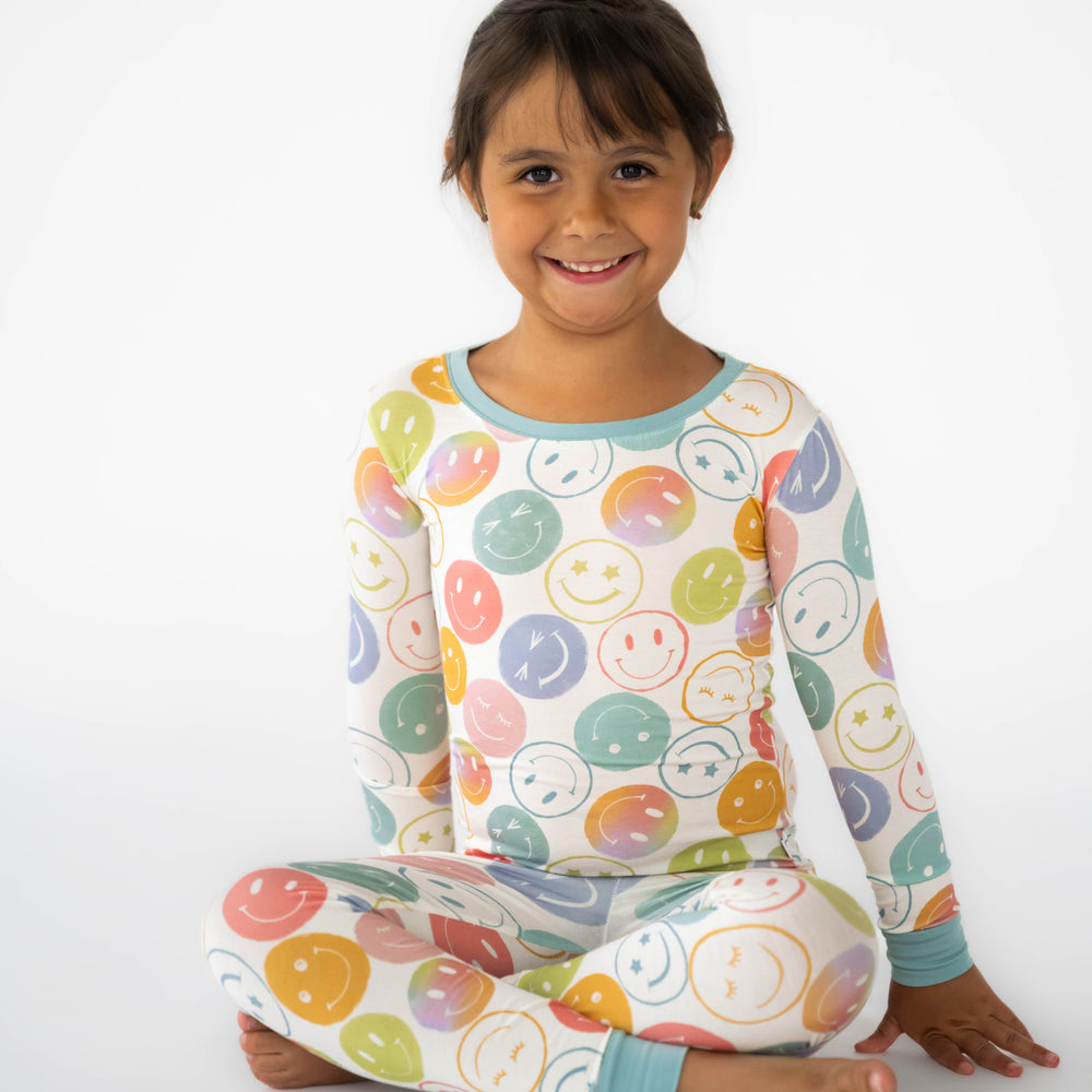 Girl sitting and wearing the Positive Vibes Two-Piece Pajama Set