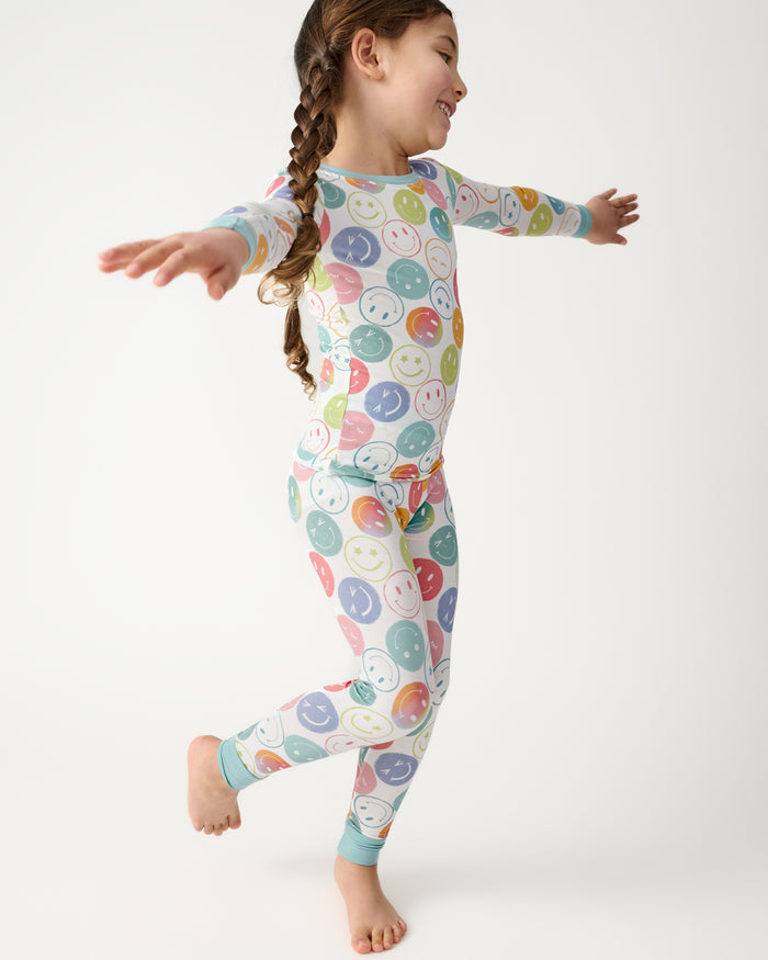 Running child wearing the Positive Vibes Two-Piece Pajama Set
