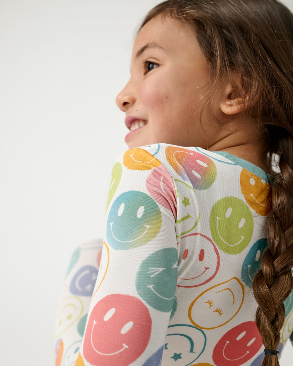 Close up of sitting child wearing the Positive Vibes Two-Piece Pajama Set