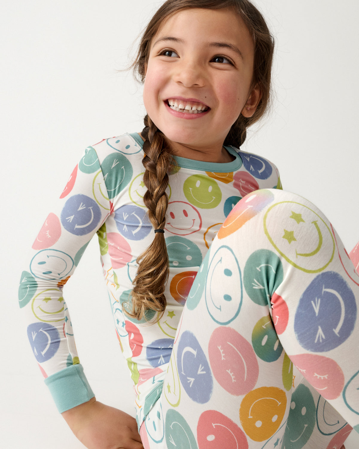 Sitting girl wearing the Positive Vibes Two-Piece Pajama Set