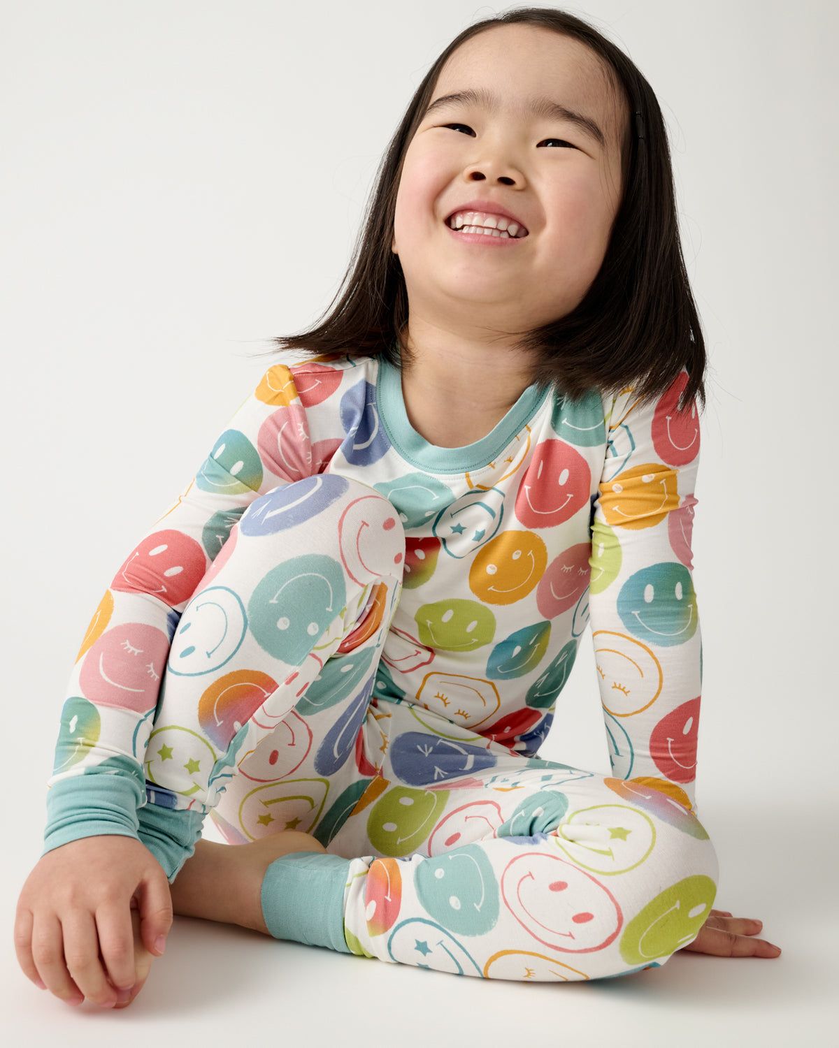 Alternate sitting girl wearing the Positive Vibes Two-Piece Pajama Set