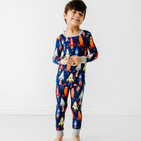 Child wearing a Navy Space Explorer two piece pajama set
