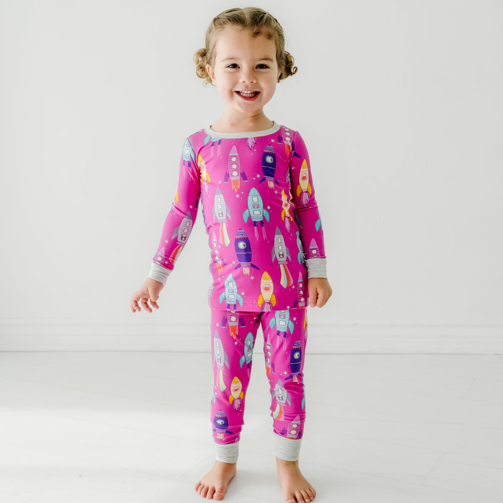 Child wearing a Pink Space Explorer two piece pajama set