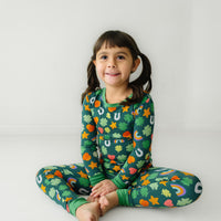 Child sitting wearing a Lucky two piece pajama set
