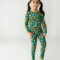 Child posing wearing a Lucky two piece pajama set