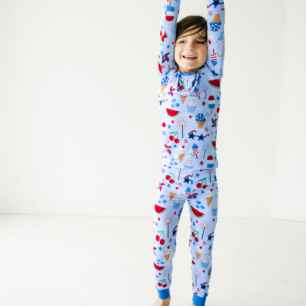 Alternate image of a child posing wearing a Stars, Stripes, and Sweets two piece pajama set